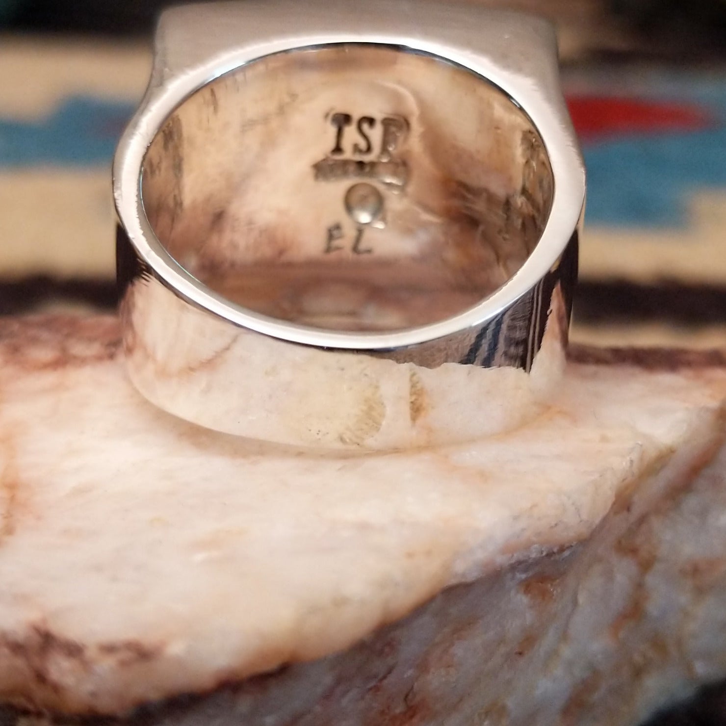 Sterling silver ring featuring a rectangular turquoise inlay and geometric channel work.