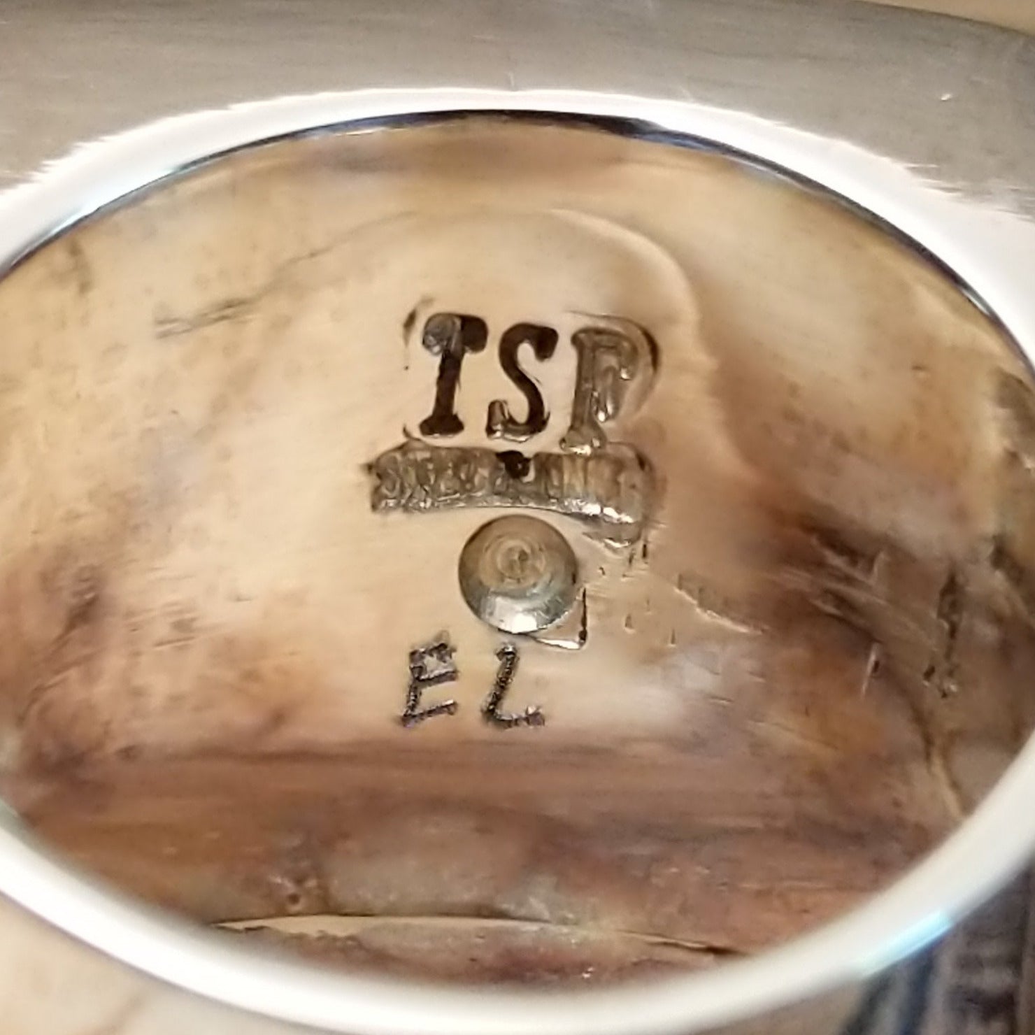 Close-up of the artist's stamped signature.