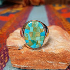 Navajo Turquoise Mosaic Ring featuring an oval face filled with geometric turquoise pieces in blue, aqua, sage, and green tones, set in a wide polished silver band.