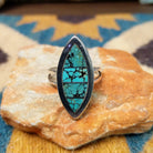 Handcrafted Navajo sterling silver navette ring featuring an elongated turquoise inlay with natural black matrix, set in a polished bezel with a split shank design.