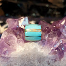 Front shows turquoise and opal inlays in gold barrel pendant.