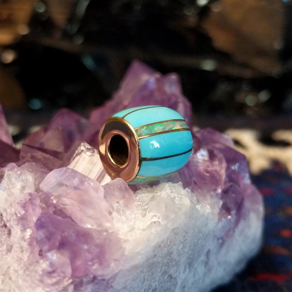Turquoise and opal inlays in gold barrel pendant in the form of a bead.