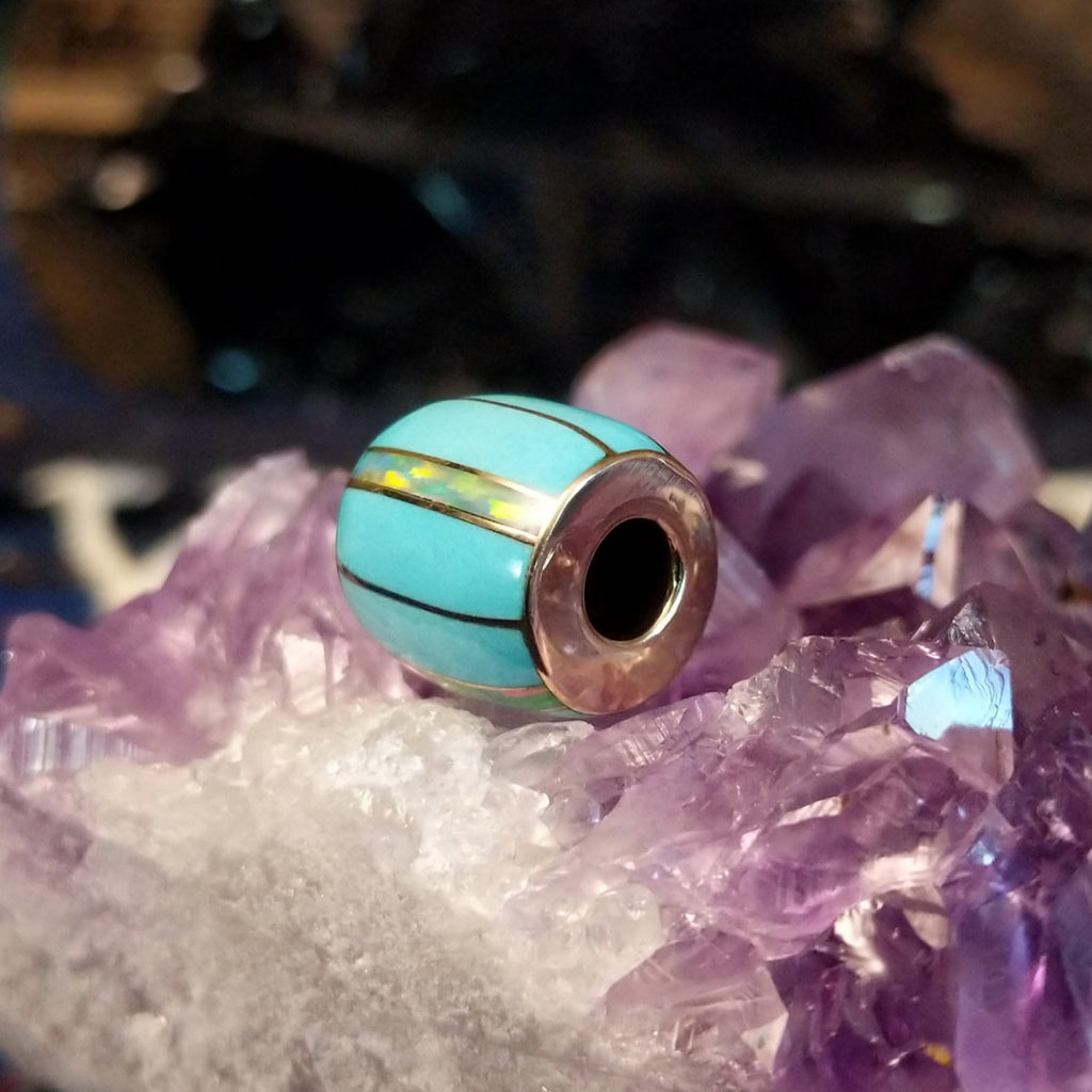 Turquoise and opal inlays in gold barrel pendant in the form of a bead.