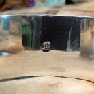 Handcrafted Navajo sterling silver cuff featuring five diamond-shaped turquoise stones in twisted rope bezels with intricate hand-stamped Southwestern designs and silver bead accents; artisan and .925 (Sterling Silver) stamp.