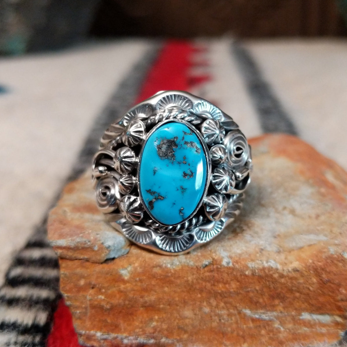 Navajo turquoise ring with layered silver leaves, drops, and wirework.