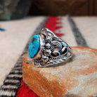 Navajo turquoise ring with layered silver leaves, drops, and wirework.