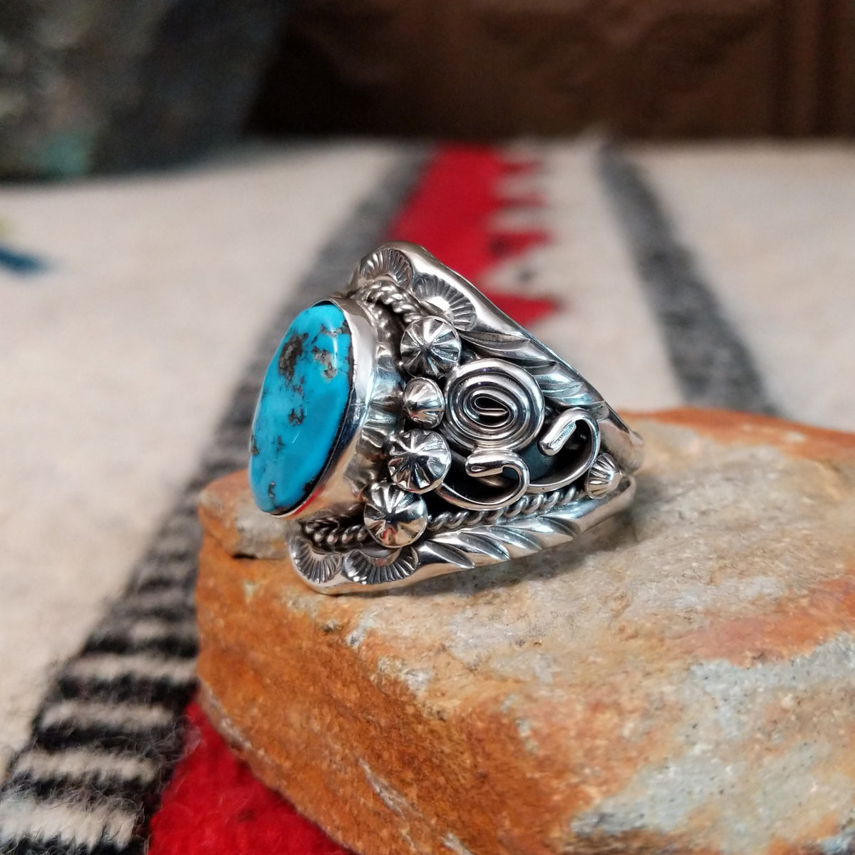 Navajo turquoise ring with layered silver leaves, drops, and wirework.