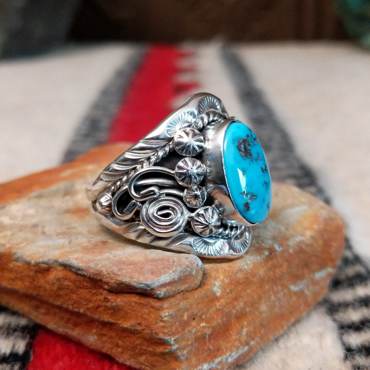 Navajo turquoise ring with layered silver leaves, drops, and wirework.