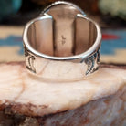 Sterling silver ring with oval turquoise set in a twisted rope bezel.