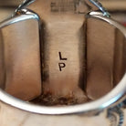 Close-up of the artist's stamped signature.