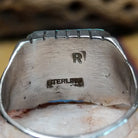 Navajo turquoise ring by R., featuring a square turquoise stone with natural blue and green tones set in a handcrafted sterling silver band with stepped side accents.  Artisan and Sterling Silver stamp.