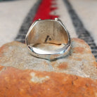 Navajo turquoise ring by S. with silver drops and tapered band.