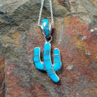 Handcrafted sterling silver turquoise inlay saguaro cactus pendant by B.J., featuring an inlay bale and traditional Navajo design.