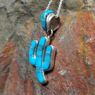 Handcrafted sterling silver turquoise inlay saguaro cactus pendant by B.J., featuring an inlay bale and traditional Navajo design; side view.