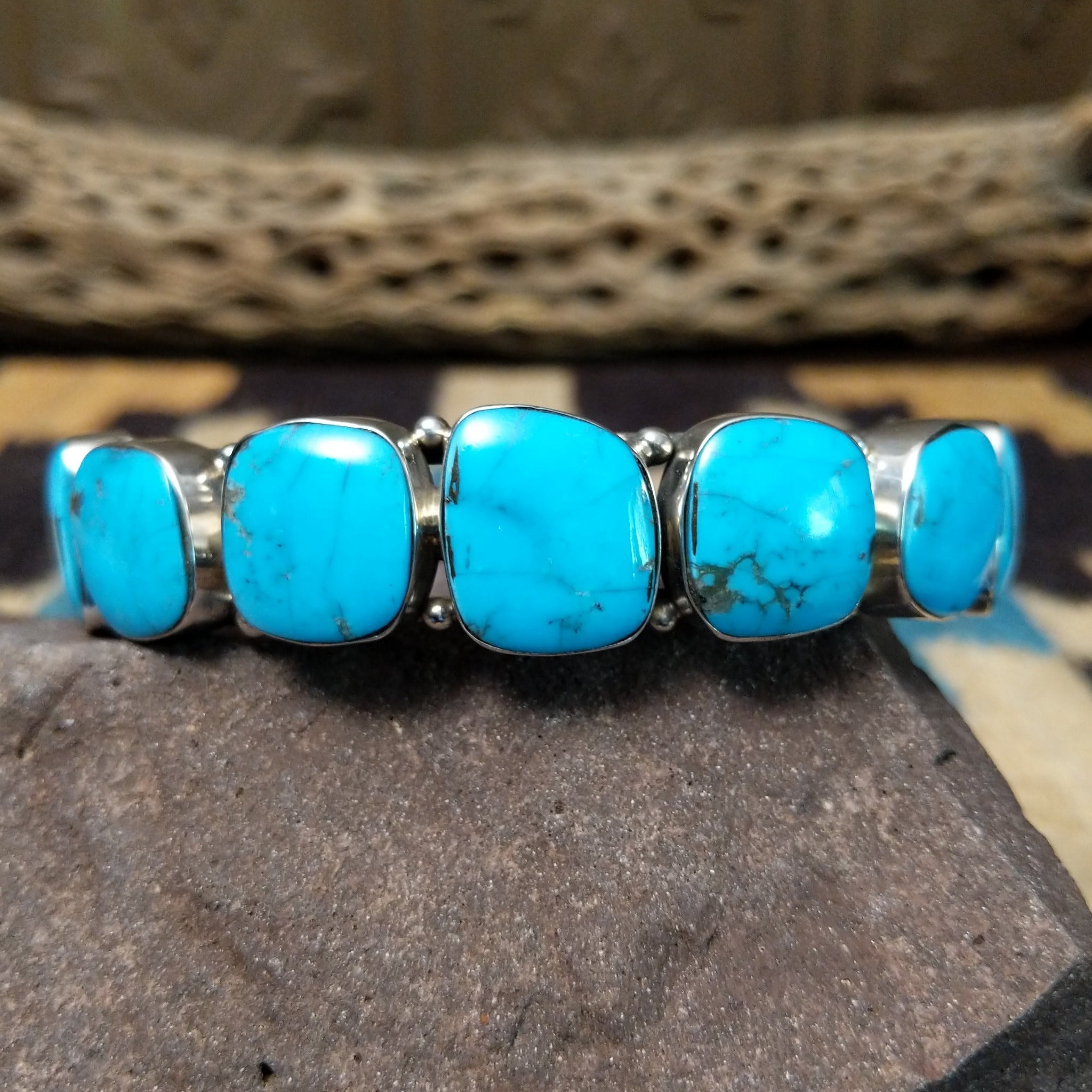 Navajo turquoise septet cuff, featuring seven blue turquoise stones with natural matrix set in a handcrafted sterling silver cuff.