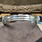 Navajo turquoise septet cuff, featuring seven blue turquoise stones with natural matrix set in a handcrafted sterling silver cuff; underside view.