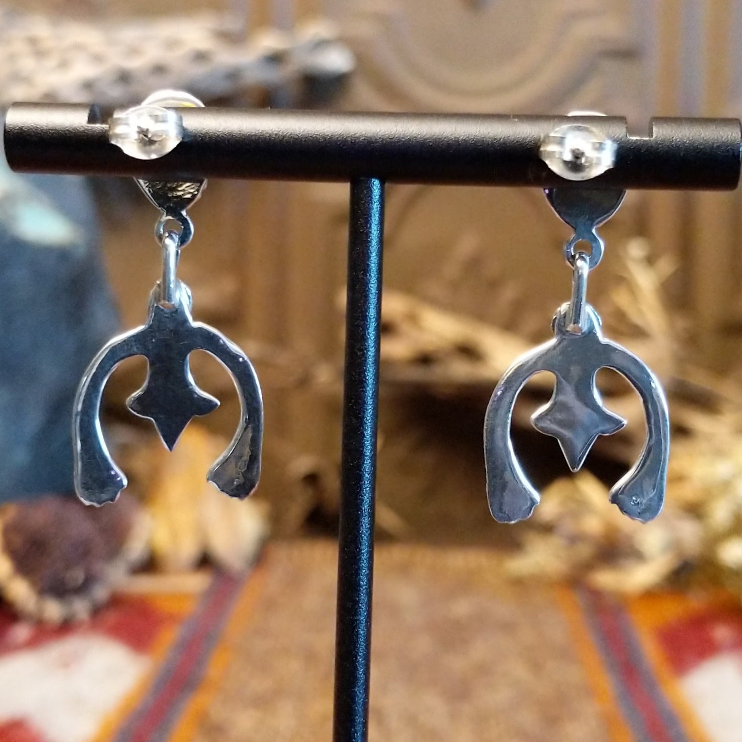 Turquoise set in bezels framed by twisted rope with the suspended naja design.