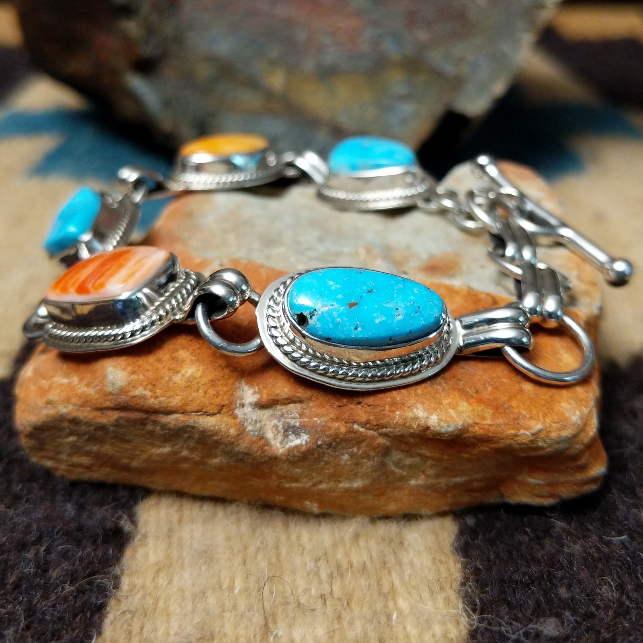 Navajo turquoise and spiny oyster link bracelet by L.P. with natural stones set in sterling silver.