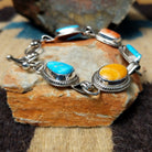 Navajo turquoise and spiny oyster link bracelet by L.P. with natural stones set in sterling silver.