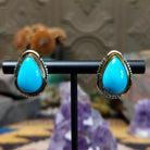 Navajo 14k gold teardrop earrings with turquoise stone and fan accents.