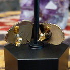 Close up of earring backing and stamped 14K indicating 14 karat gold construction.