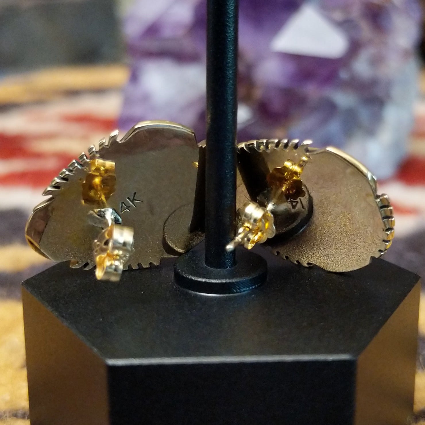 Close up of earring backing and stamped 14K indicating 14 karat gold construction.