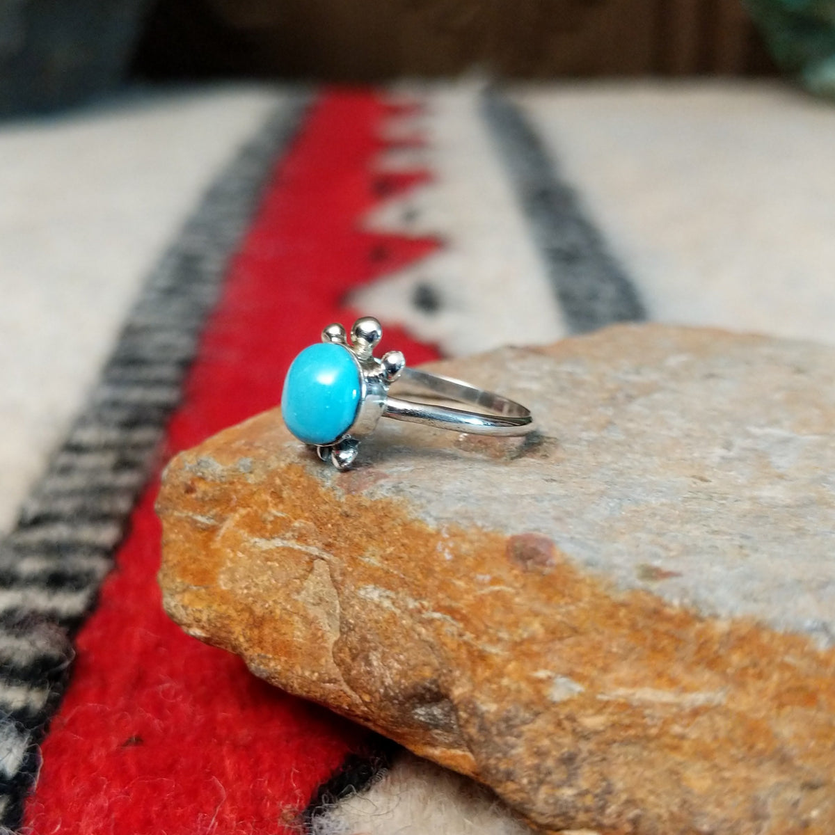 Navajo silver turtle ring with round turquoise stone.