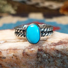 Sterling silver ring with turquoise set in the oval bezel and twisted silver band.