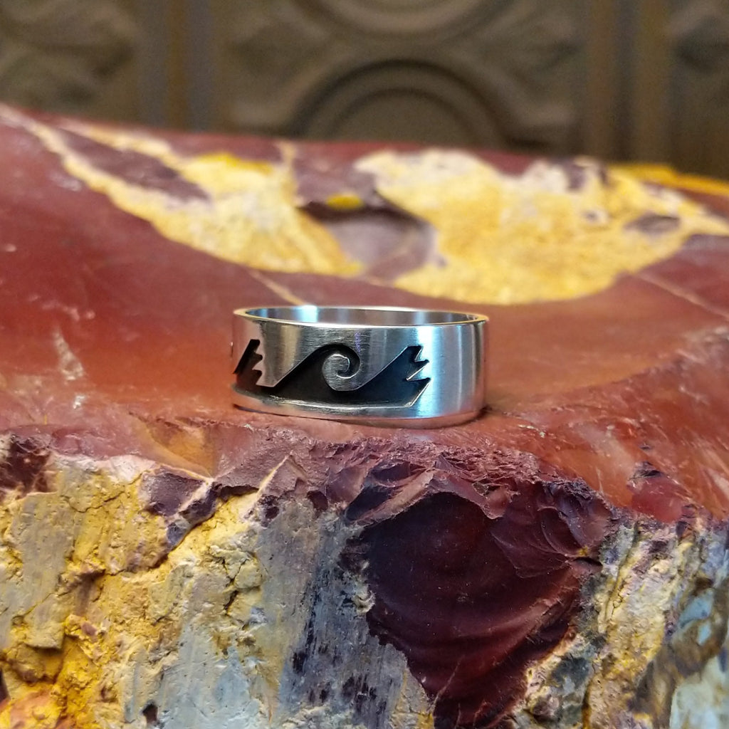 Sterling silver ring with water waves and rain clouds along the surface.