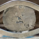 Close-up of the artisan's stamped signature.