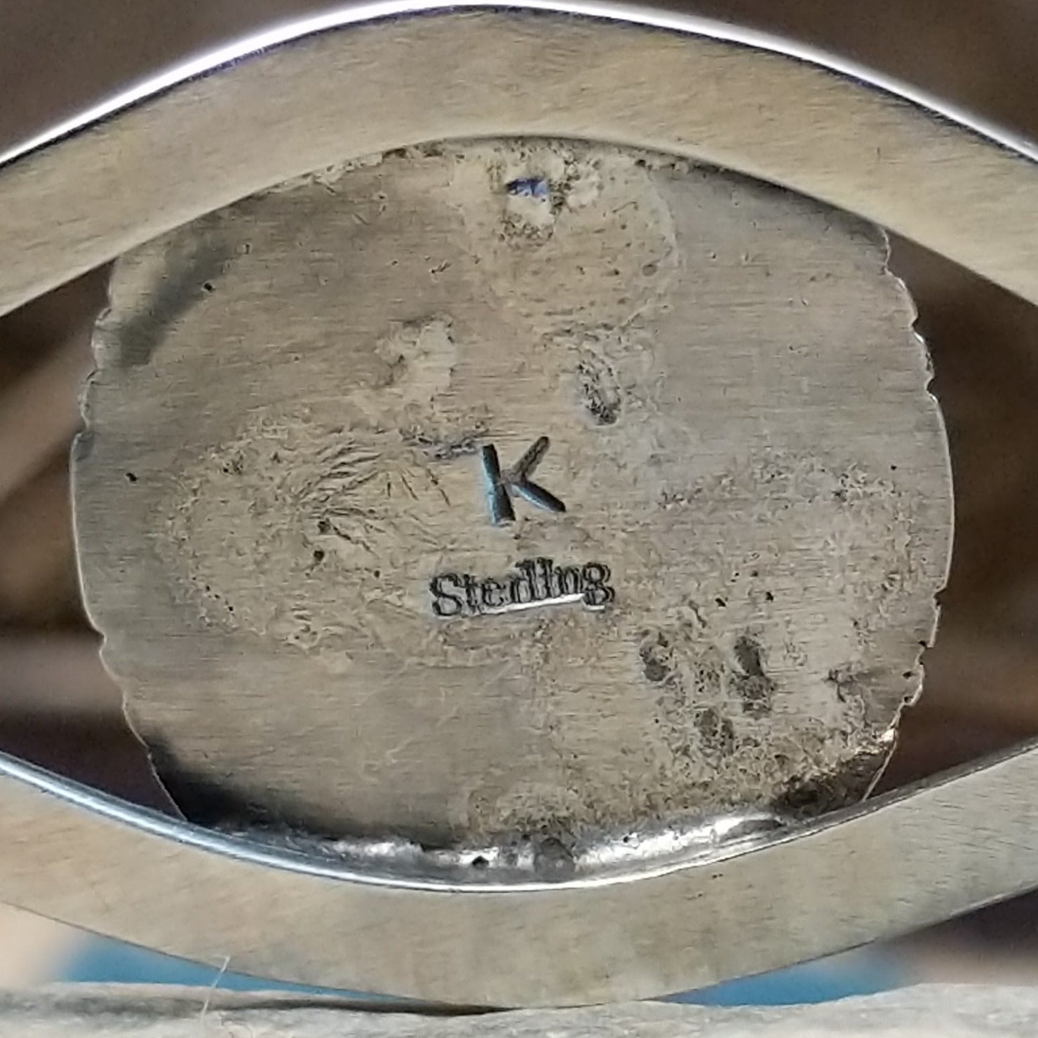 Close-up of the artisan's stamped signature.