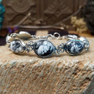 Sterling silver link bracelet with white buffalo set in oval bezels.