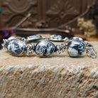Sterling silver link bracelet with white buffalo set in oval bezels.