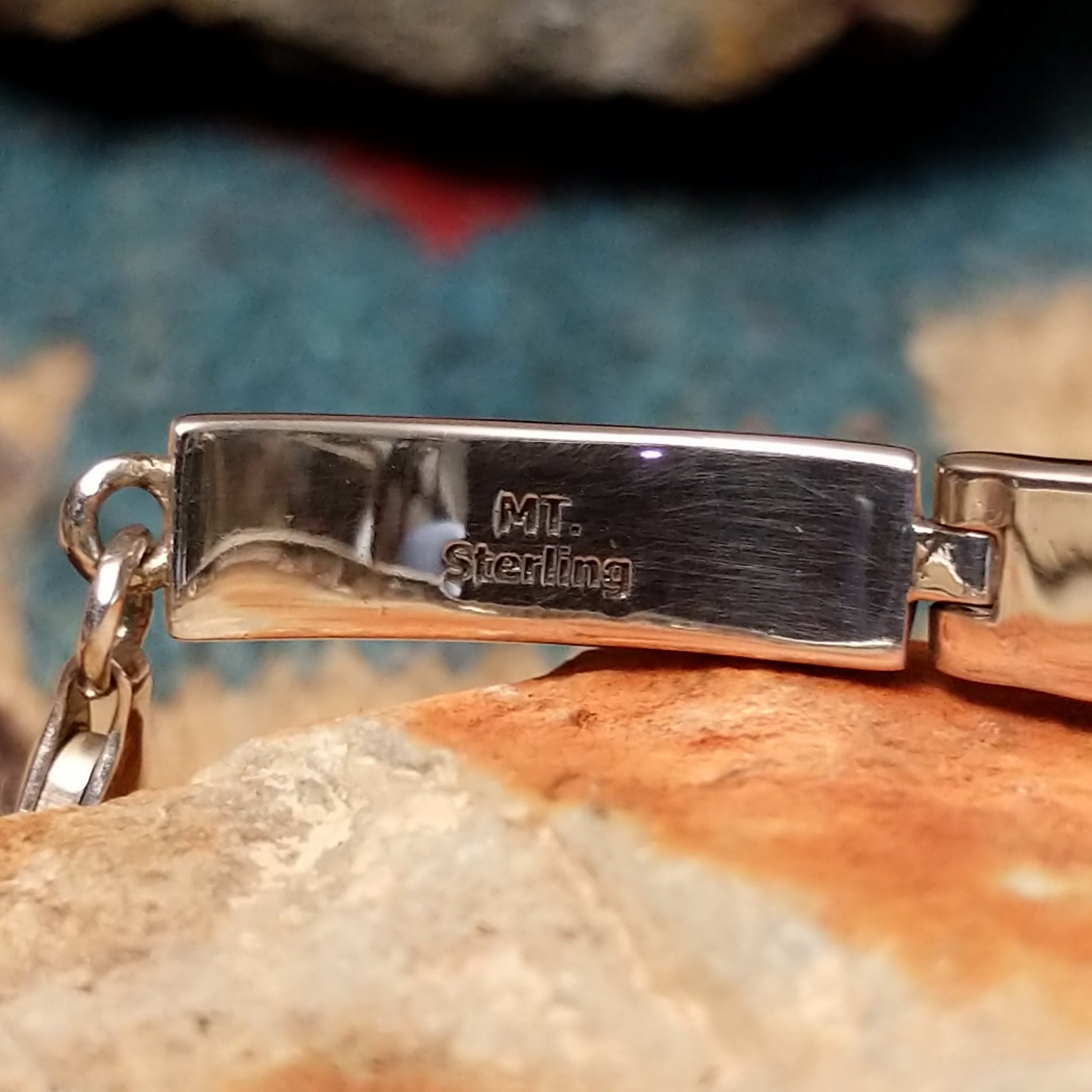 Navajo White Buffalo link bracelet by M.T. with black and white inlay set in sterling silver; artisan and Sterling Silver stamp.
