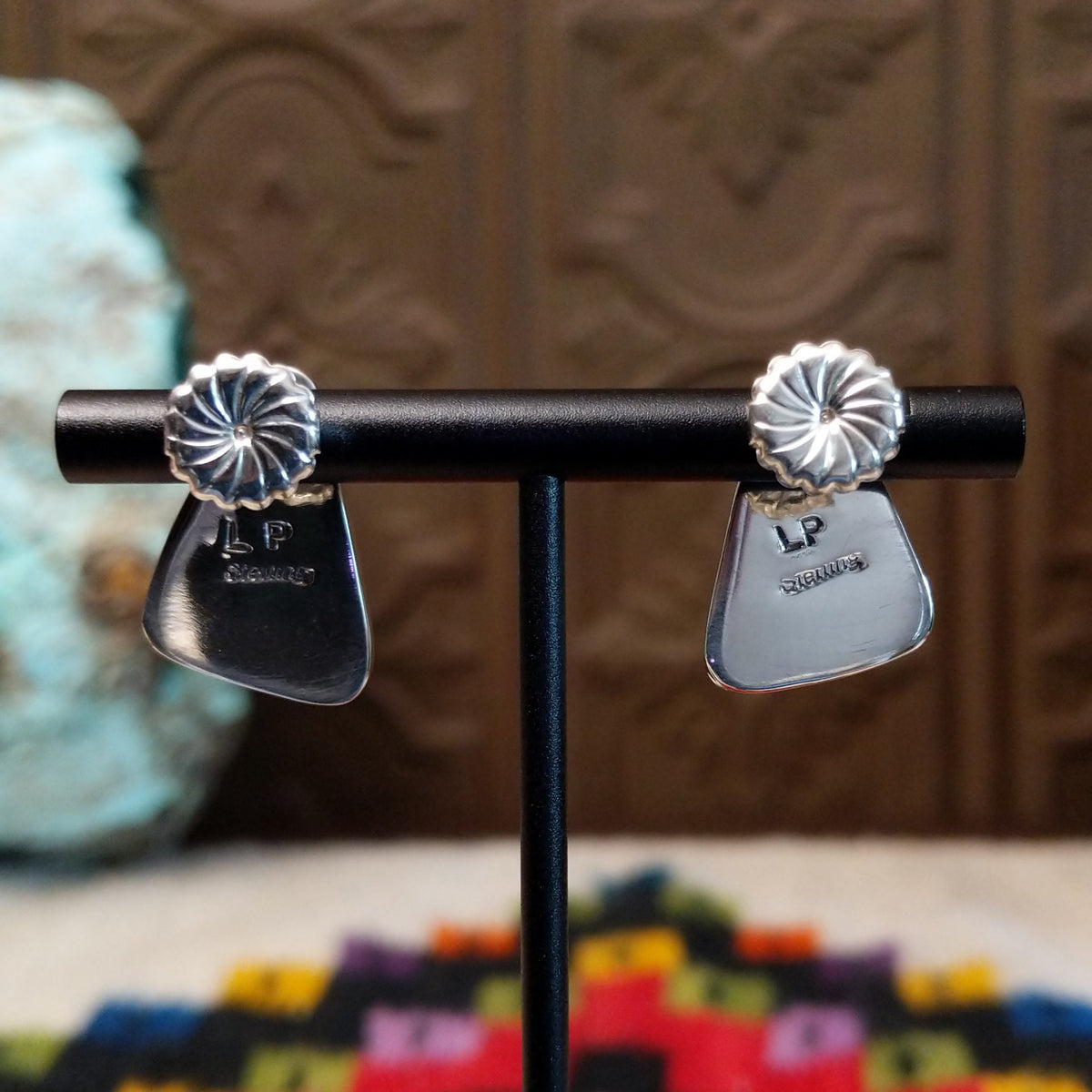Navajo White Buffalo Triangle Earrings by L.P. featuring polished triangular white stones with natural black matrix patterns set in smooth silver bezels; artisan and Sterling Silver stamp.
