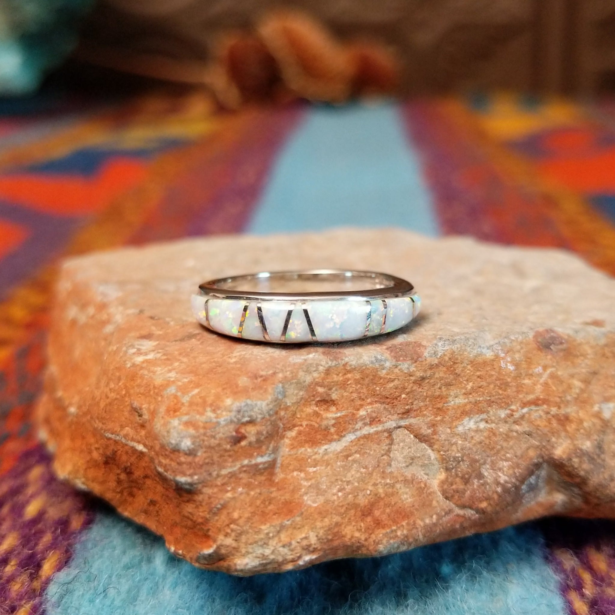 Navajo silver band ring with inlaid white manmade opal inlay.