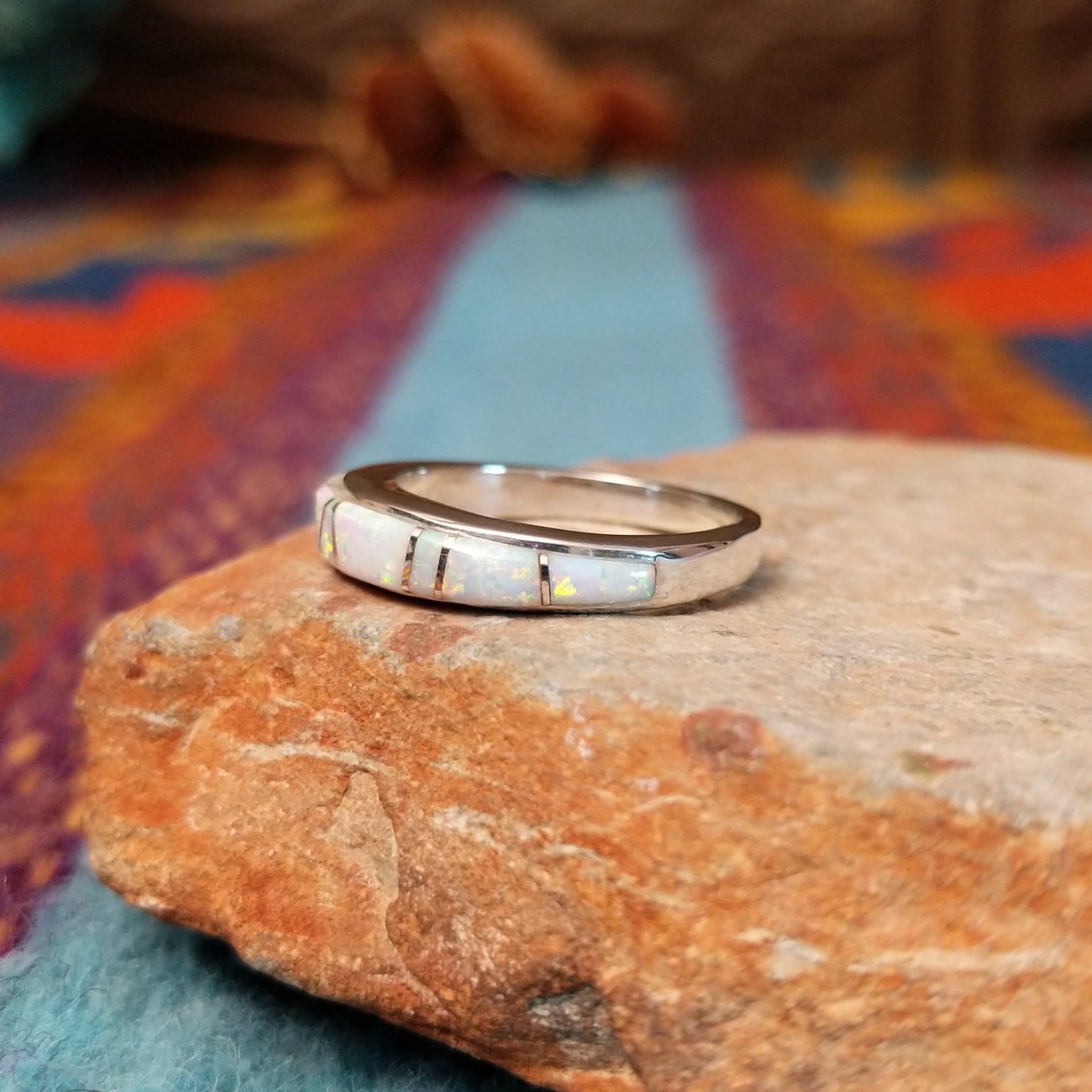 Navajo silver band ring with inlaid white manmade opal inlay.