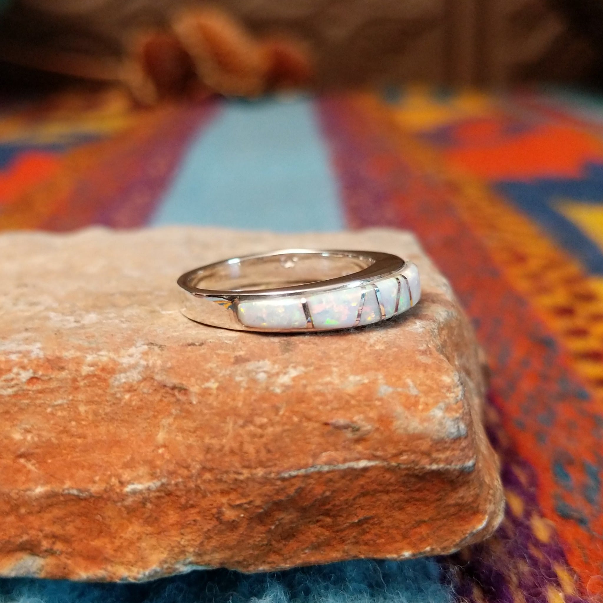 Navajo silver band ring with inlaid white manmade opal inlay.