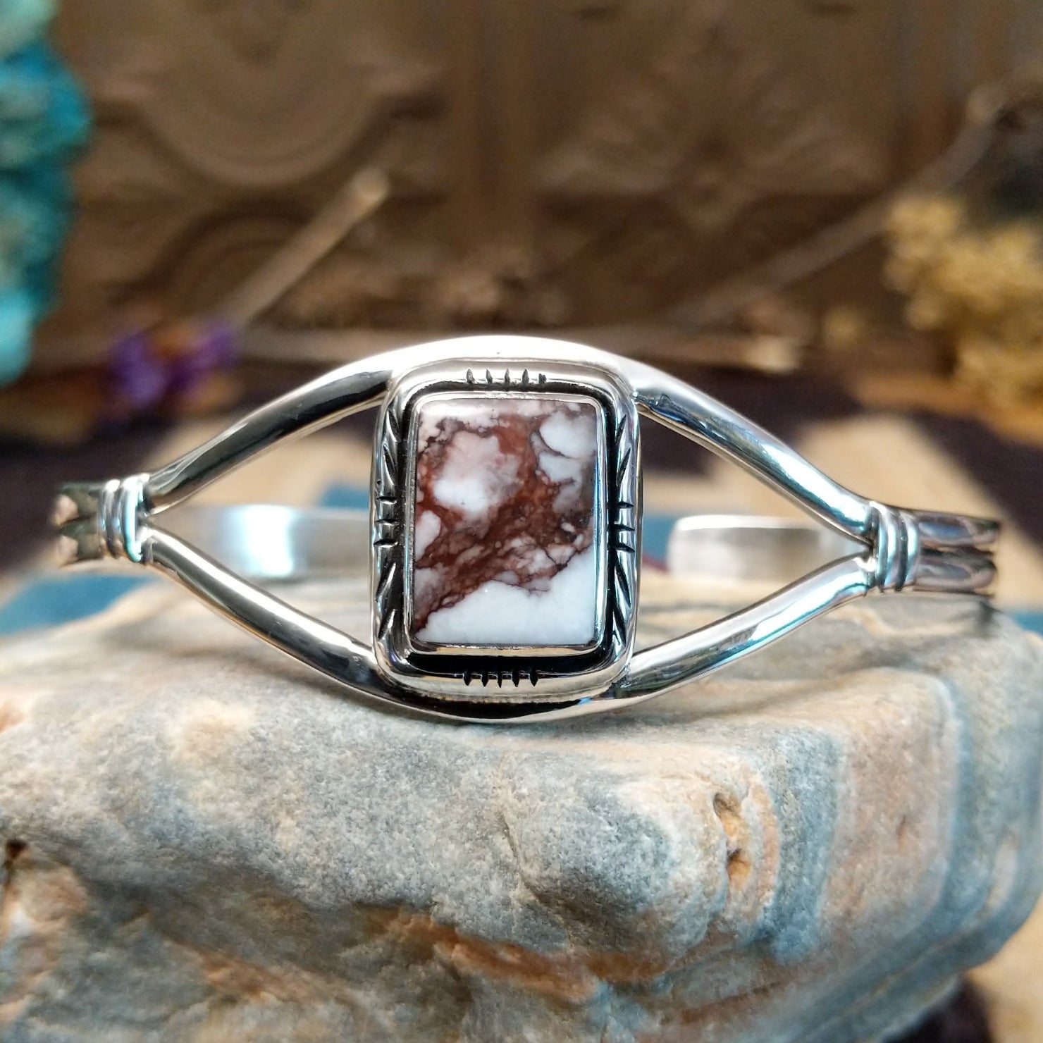Sterling silver cuff with wild horse stone set in a rectangular bezel, framed by incised lining and a delicate band.