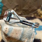 Sterling silver cuff with wild horse stone set in a rectangular bezel, framed by incised lining and a delicate band.