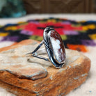 Navajo Wild Horse Ring by P. with elongated stone and stamped setting.