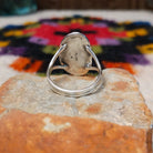 Navajo Wild Horse Ring by P. with elongated stone and stamped setting.