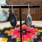Navajo Wild Horse Teardrop Earrings by B.A. featuring polished white and reddish-brown matrix stones in detailed silver settings with French ear wires; artisan and Sterling Silver stamp.