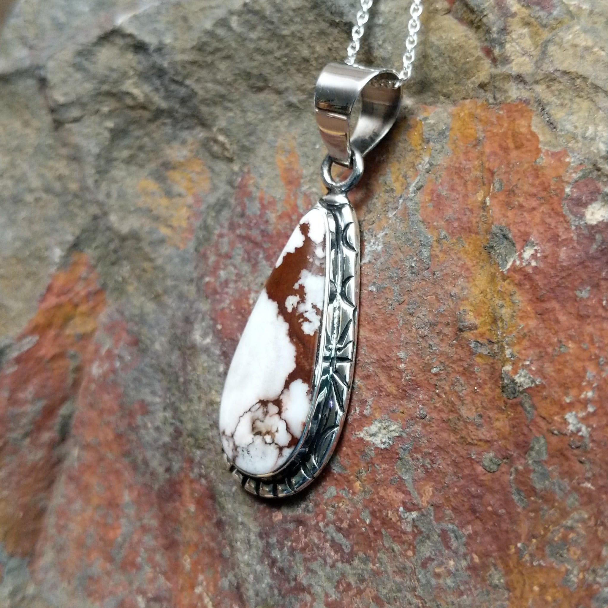 Handcrafted sterling silver Navajo Wild Horse teardrop pendant featuring a natural Wild Horse gemstone in a classic bezel setting; side view.