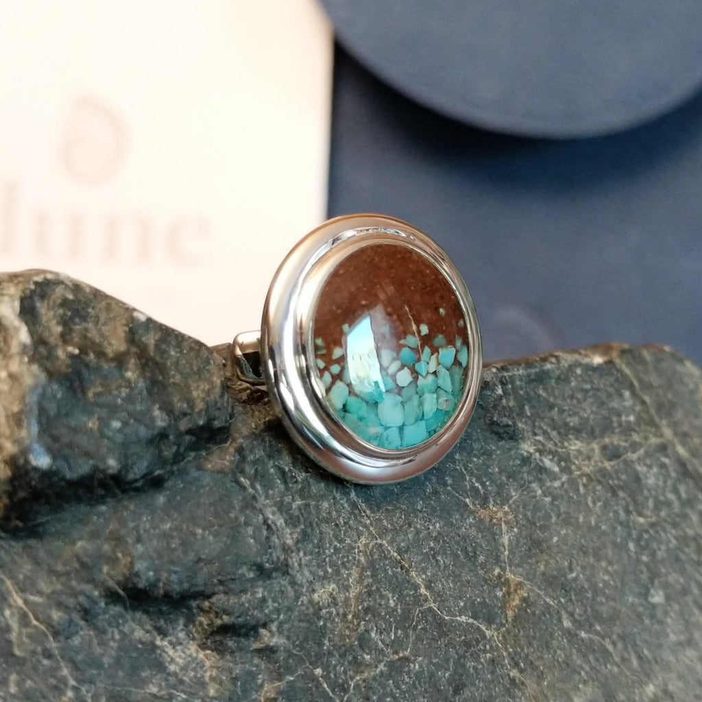 Turquoise flakes and Lake Powell sand set in round sterling silver bezel of the ring.