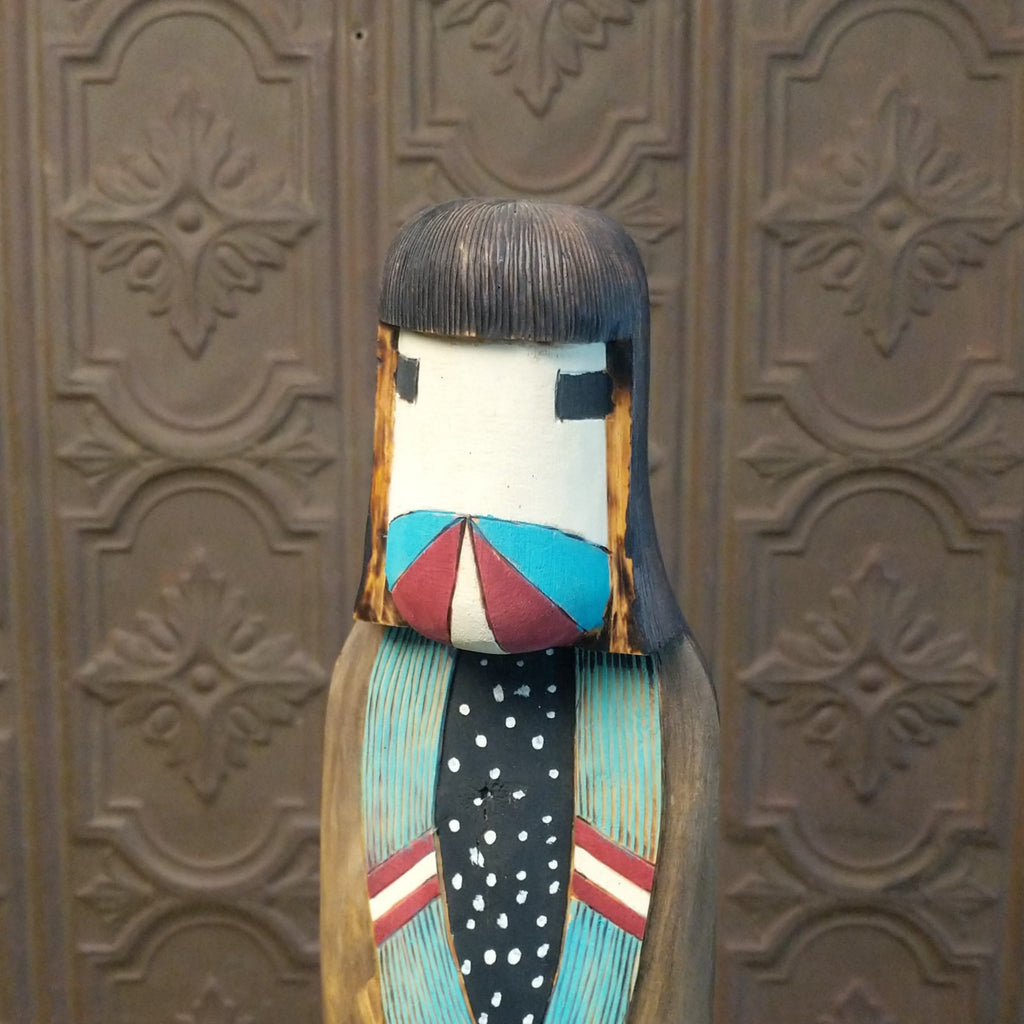 A close-up view of the painted face of the figure.