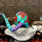 Back view of detachable tail with dotting and purple plates.