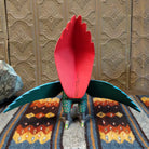Back view of tails and open wings painted with vibrant colors.