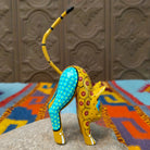 Oaxacan cat wood carving with a tall upright body, detachable parts, and colorful hand-painted geometric patterns.