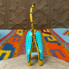 Oaxacan cat wood carving with a tall upright body, detachable parts, and colorful hand-painted geometric patterns.